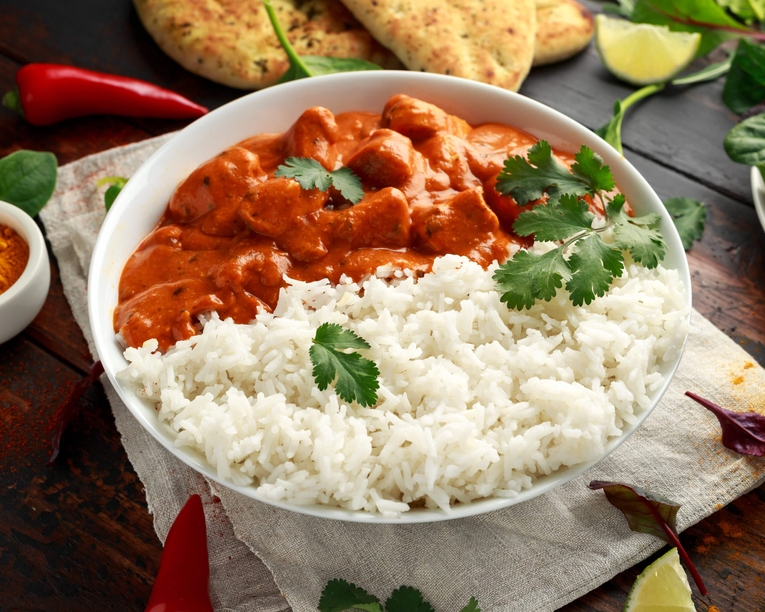 Chicken tikka masala curry with rice and naan bread.